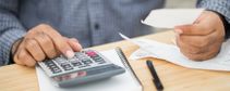 Man Working Out Costs Using Calculator