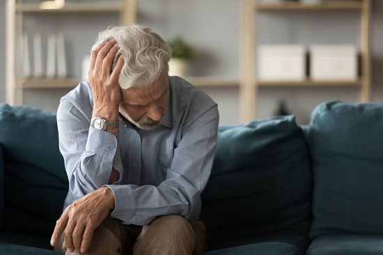 Senior man experiencing one of the five stages of grief