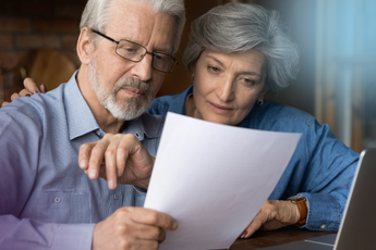 Couple reading funeral plan document