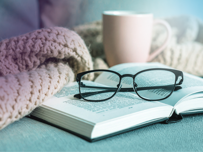 book and glasses on table