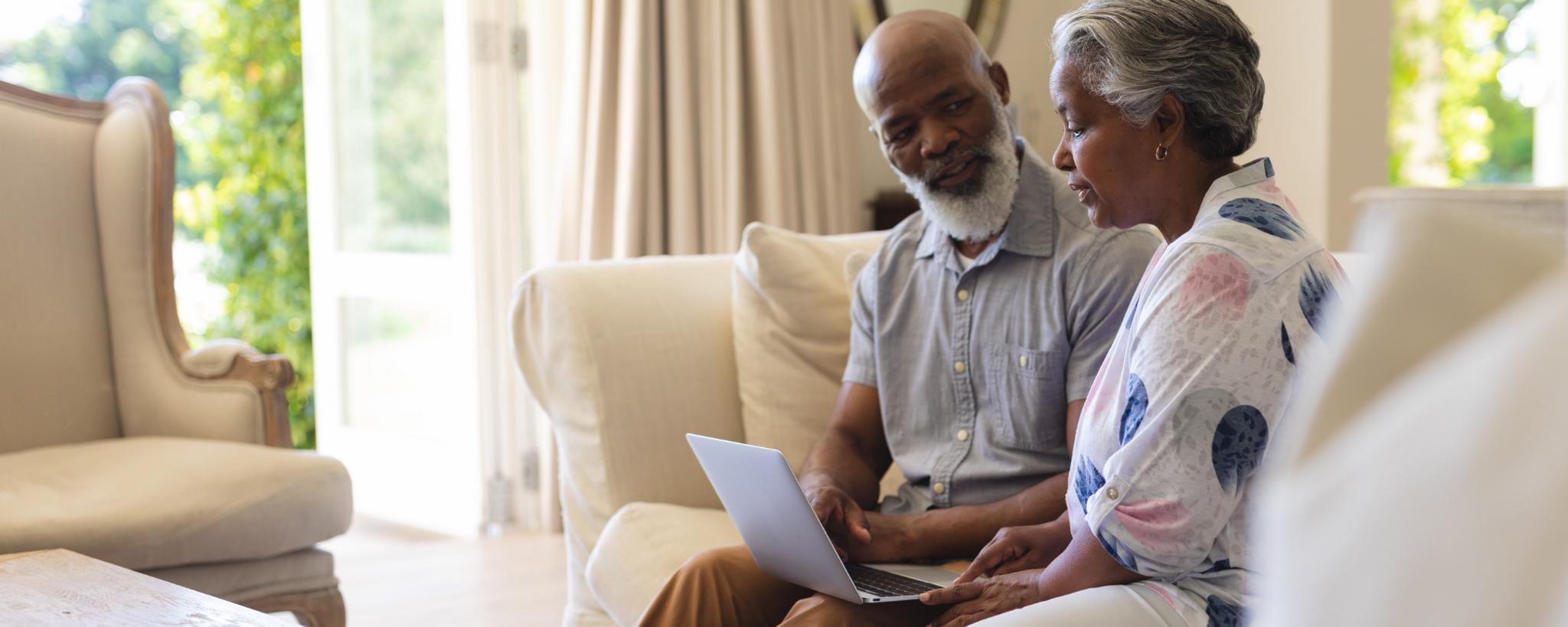 Elderly couple reviewing funeral prices _ Distinct Cremations