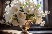 White Funeral Flowers In Metal Vase In Chapel