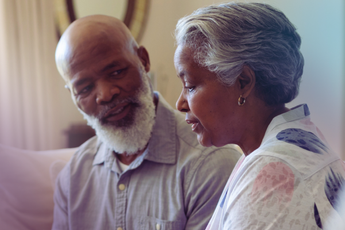 Couple on sofa discussing funeral