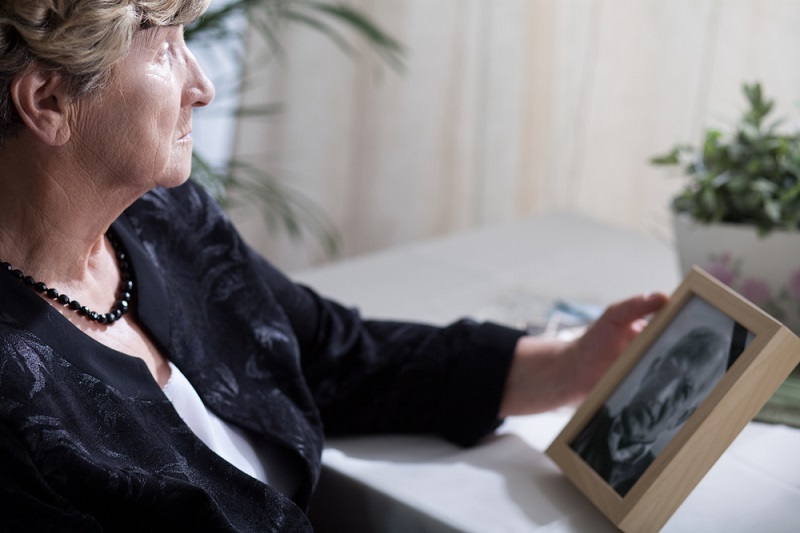 Woman Calculating Cost of Funeral