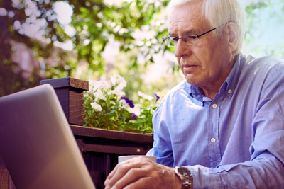 Man on laptop exploring funeral plans