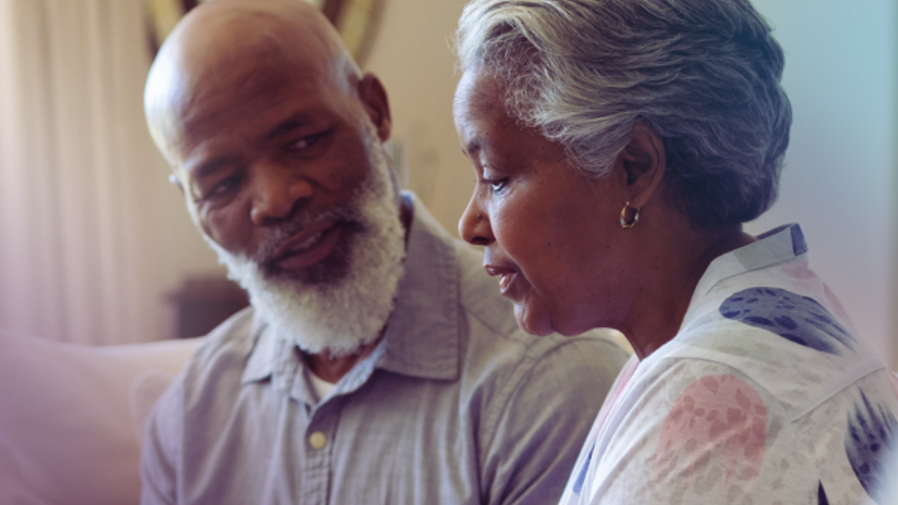 Couple on sofa discussing funeral