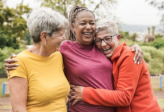 Senior friends hugging and supporting one another