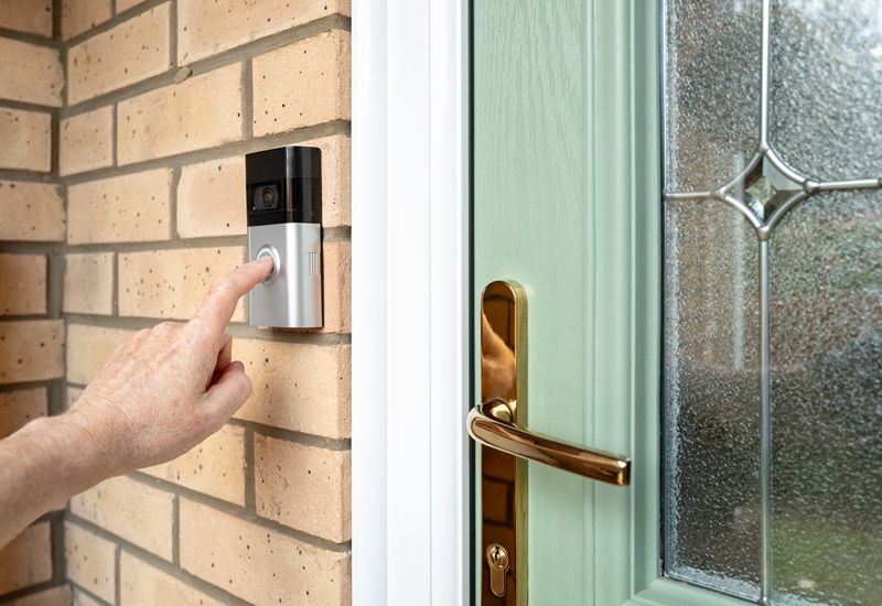 Person Ringing Doorbell Of House