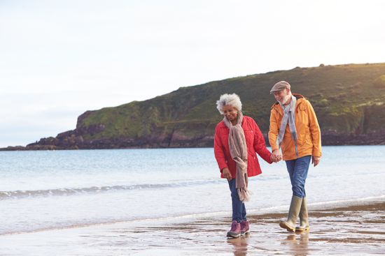 Couple waking on beach